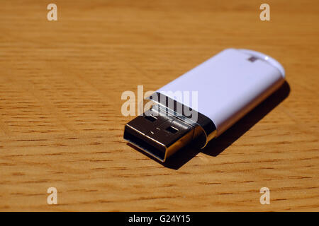 A USB memory stick on a wooden table Stock Photo