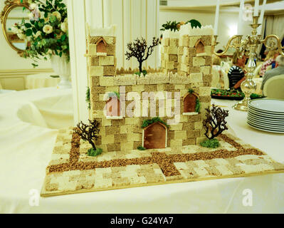 A decorative castle made from different types of bread on a table in a hotel dinning room Stock Photo