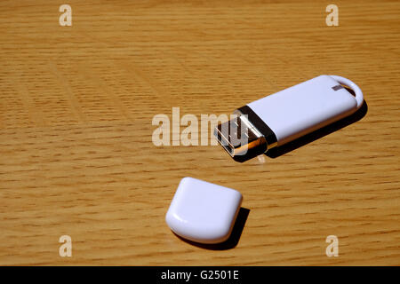 A USB memory stick on a wooden table Stock Photo