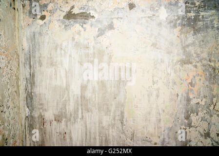 Old concrete wall with remnants of plaster and paint. Background texture Stock Photo