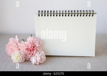 Notepad with pink flowers mock up, selective focus Stock Photo
