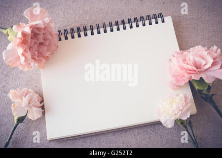 Notepad with pink flowers mock up, selective focus, toning Stock Photo
