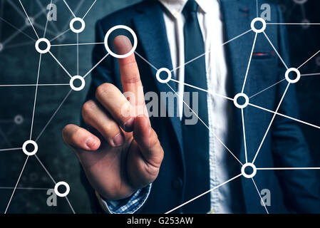 Businessman connecting the dots in business project management, social networking or teamwork organization. Stock Photo