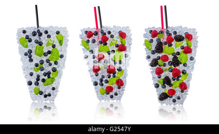 Ice fresh drinks made of blueberries, raspberries and blackberries placed on ice cubes. Isolated on white background Stock Photo