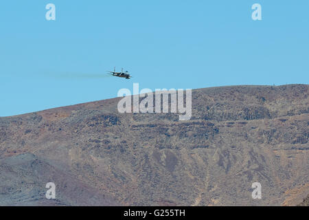 Massachusetts Air National Guard F-15C Eagle Jet Fighter Flying At Low Level Over Rainbow Canyon, California. Stock Photo