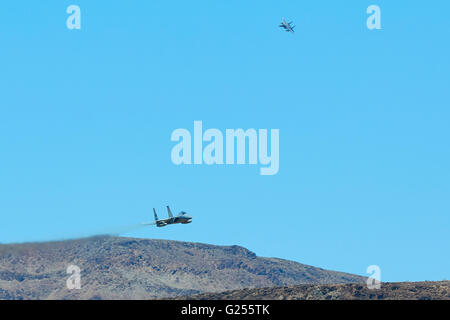 Pair Of Massachusetts Air National Guard F-15C Eagle Jet Fighters Diving Into Rainbow Canyon, California. Stock Photo