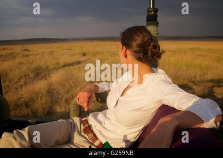 Woman looking at Masai Mara plains, Kenya Stock Photo