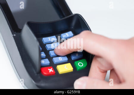 Entering Pin Code in a reading device for payment in a shop Stock Photo