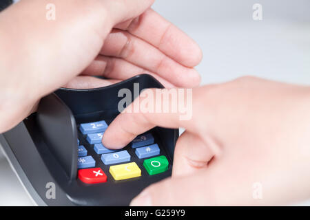 Entering a PIN Code in a card reader (payment) Stock Photo