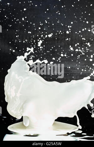 Milk splashing from a cup Stock Photo