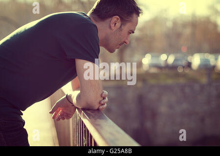 man leaning on railing
