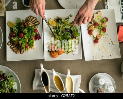 Woman eating salads in restaurant Stock Photo