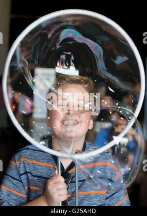 Portrait of a Boy blowing large bubbles Stock Photo