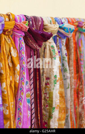 Close-up of multi coloured scarves hanging on rail Stock Photo