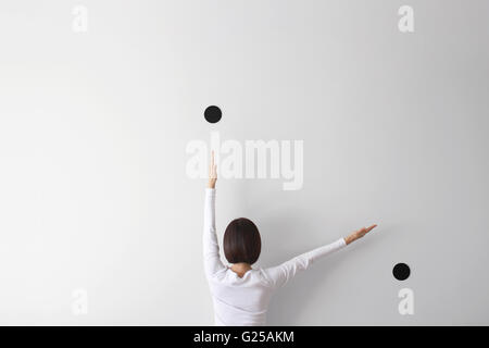 Rear view of woman making conceptual clock face Stock Photo