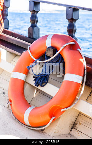 Close-up of Orange life buoy on boat Stock Photo