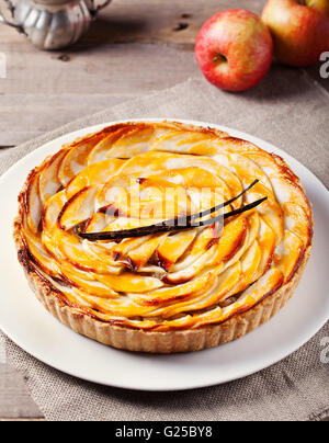 Apple tart with vanilla pod on a white plate Traditional holiday dessert Stock Photo