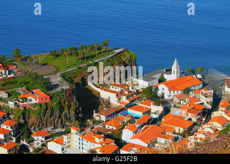 Cape rock and town on coast. Camara-de-Lobos, Madeira, Portugal Stock Photo