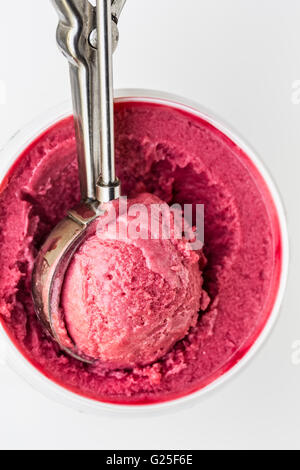 Raspberry ice cream scoop in a tin Stock Photo