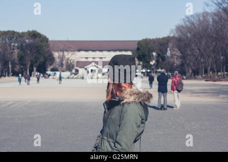 A young woman is walking in Ueno park in Tokyo Stock Photo