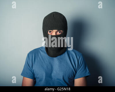 A scary young man is wearing a balaclava Stock Photo