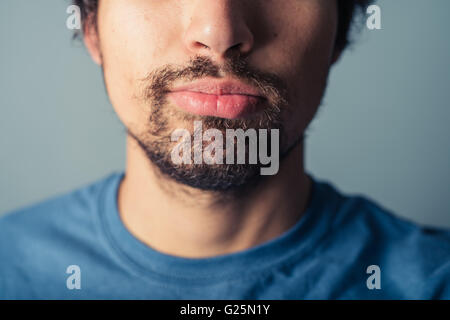 A young man with a beard is pulling silly faces Stock Photo