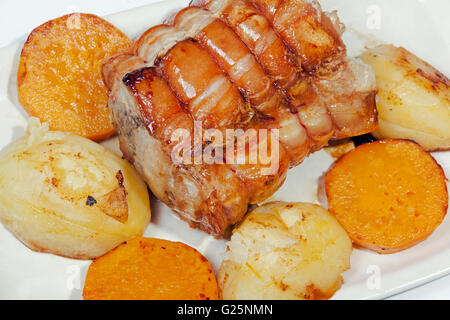 Close up overview studio shot of roasted rolled pork pumpkin and potatoes Stock Photo