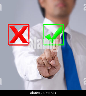 Close up businessman touching ticking icon of media screen Stock Photo
