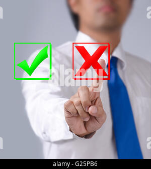 Businessman touches of the button wrong in front Stock Photo