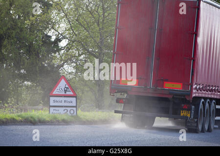 Skid risk for slowing truck on re-surfaced British road. Stock Photo