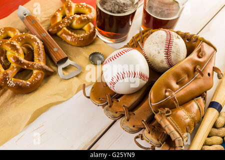 Close up of old worn baseball equipment on a wooden background. Stock Photo