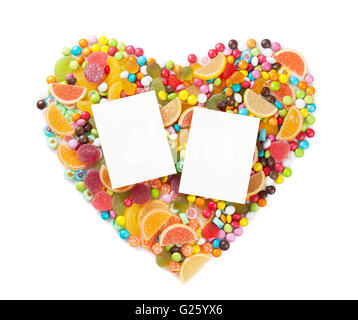 Colorful candies, jelly and marmalade heart with two photo frames. Isolated on white background Stock Photo