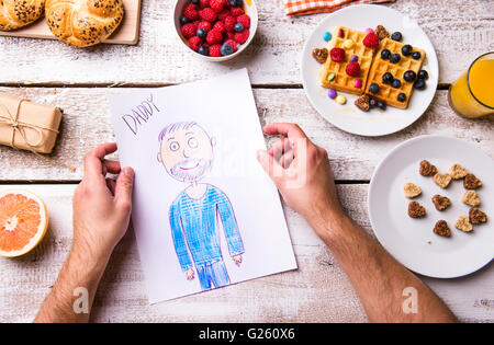 Childs drawing of her dad. Fathers day. Breakfast meal. Stock Photo
