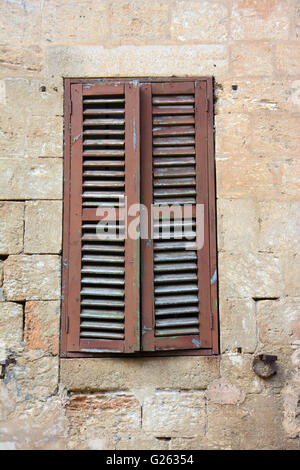 Old window in stone brick wall Stock Photo