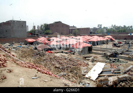 View of demolished wall of Orange Line train project under- construction godown after wall collapsed incident near Quaid-e-Azam Terminal at GT road in Lahore on Tuesday, May 24, 2016. At least seven labours working on the Orange Line train project lost their lives when the wall of an under-construction godown collapsed on them as they were sleeping in their tents. Credit:  Babar Shah/PPI Images/Alamy Live News Stock Photo