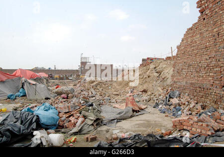 View of demolished wall of Orange Line train project under- construction godown after wall collapsed incident near Quaid-e-Azam Terminal at GT road in Lahore on Tuesday, May 24, 2016. At least seven labours working on the Orange Line train project lost their lives when the wall of an under-construction godown collapsed on them as they were sleeping in their tents. Stock Photo