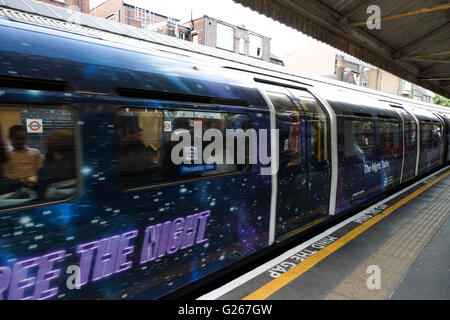 London, England. 24 May 2016. A specially decorated Picadilly Line train at Barons Court station publicises 'The Night Tube' which is due to start on 19 August 2016 on the Central and Victoria Lines with other lines being phased in later on. Credit:  Peter Hogan/ Alamy Live News Stock Photo