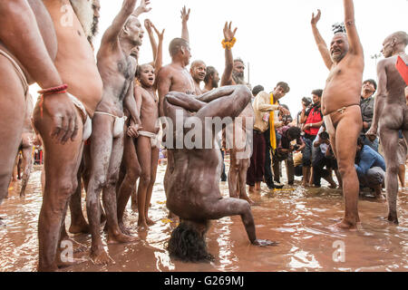 Ujjain, Madhya Pradesh, India, May 21, 2016: A Holy Hindu Monks (Naga Sadhu) is exhibiting the body fitness before taking the holy dip in the early morning on the bank of scared river Shipra, also known as Kshipra on the concluding day of month long Simhasth Mahakumbh in ancient religious city Ujjain, India. Simhasth Kumbh Mahaparv is one of the four Kumbh Melas celebrated by largest spiritual gathering on Planet Earth. This year's Simhasth Kumbh Maha Parva is based on the celestial line-up of Planets and the Signs of the Zodiac, which occurs every 12 years. This year Simhasth Kumbh Mahaparv t Stock Photo