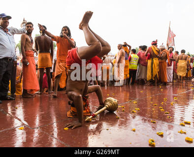 Ujjain, Madhya Pradesh, India, May 21, 2016: A Holy Hindu Monks (Naga Sadhu) is exhibiting the body fitness before taking the holy dip in the early morning on the bank of scared river Shipra, also known as Kshipra on the concluding day of month long Simhasth Mahakumbh in ancient religious city Ujjain, India. Simhasth Kumbh Mahaparv is one of the four Kumbh Melas celebrated by largest spiritual gathering on Planet Earth. This year's Simhasth Kumbh Maha Parva is based on the celestial line-up of Planets and the Signs of the Zodiac, which occurs every 12 years. This year Simhasth Kumbh Mahaparv t Stock Photo