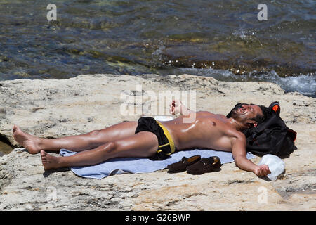 Beirut, Lebanon. 25th May 2016. A sunbather by the seafront  on a hot day in the Lebanese capital Credit:  amer ghazzal/Alamy Live News Stock Photo