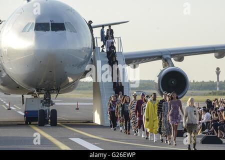 Helsinki, Finland. 24th May, 2016. Models displayed the latest collection during the Ultimate Runway Fashion Show at Helsinki Airport, Finland, on May 24, 2016. A unique fashion show was held on Tuesday night at the Runway 2 of Helsinki Airport, which was transformed into a catwalk and enabled seven designers from China, Korea, Japan, the UK, Sweden, Denmark and Finland to present their collections. © Sergei Stepanov/Xinhua/Alamy Live News Stock Photo