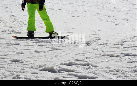 Snow Boarder - close up of Snow Boarder legs on the slope Stock Photo