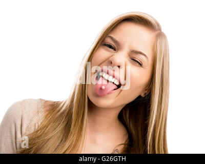 Studio portrait of a beautiful teenager girl showing her piercing in her tongue Stock Photo