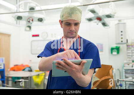 A theatre techician checks data on his Ipad Stock Photo