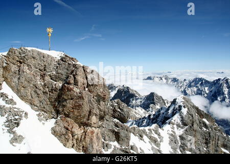 Gold cross marks the summit (Gipfel in German) of the Zugspitze, highest point in Germany. Stock Photo