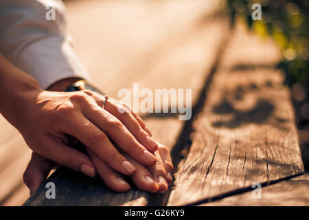 Wedding couple holding hands on sunset background Stock Photo
