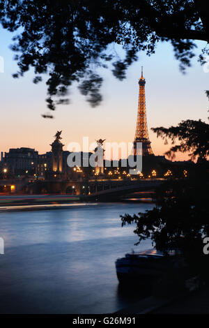 PARIS - October 23: Eiffel tower and Alexandre III bridge at dusk on October 23, 2011 in Paris. The Eiffel tower is the most vis Stock Photo