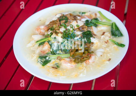 Flat rice noodles wok fried with seafood, chicken, and vegetables served with egg gravy also known as Hor Fun Stock Photo