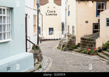 Cod & Lobster pub overlooking sea at end of cobbled street in Staithes, North Yorkshire, England. UK Stock Photo