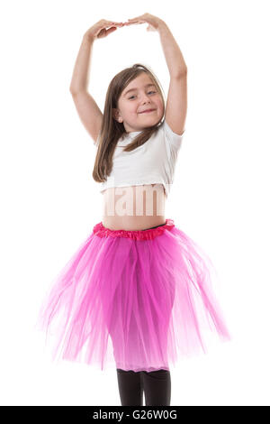 Pretty young girl in a bright pink tutu with her arms raised above her head. Stock Photo